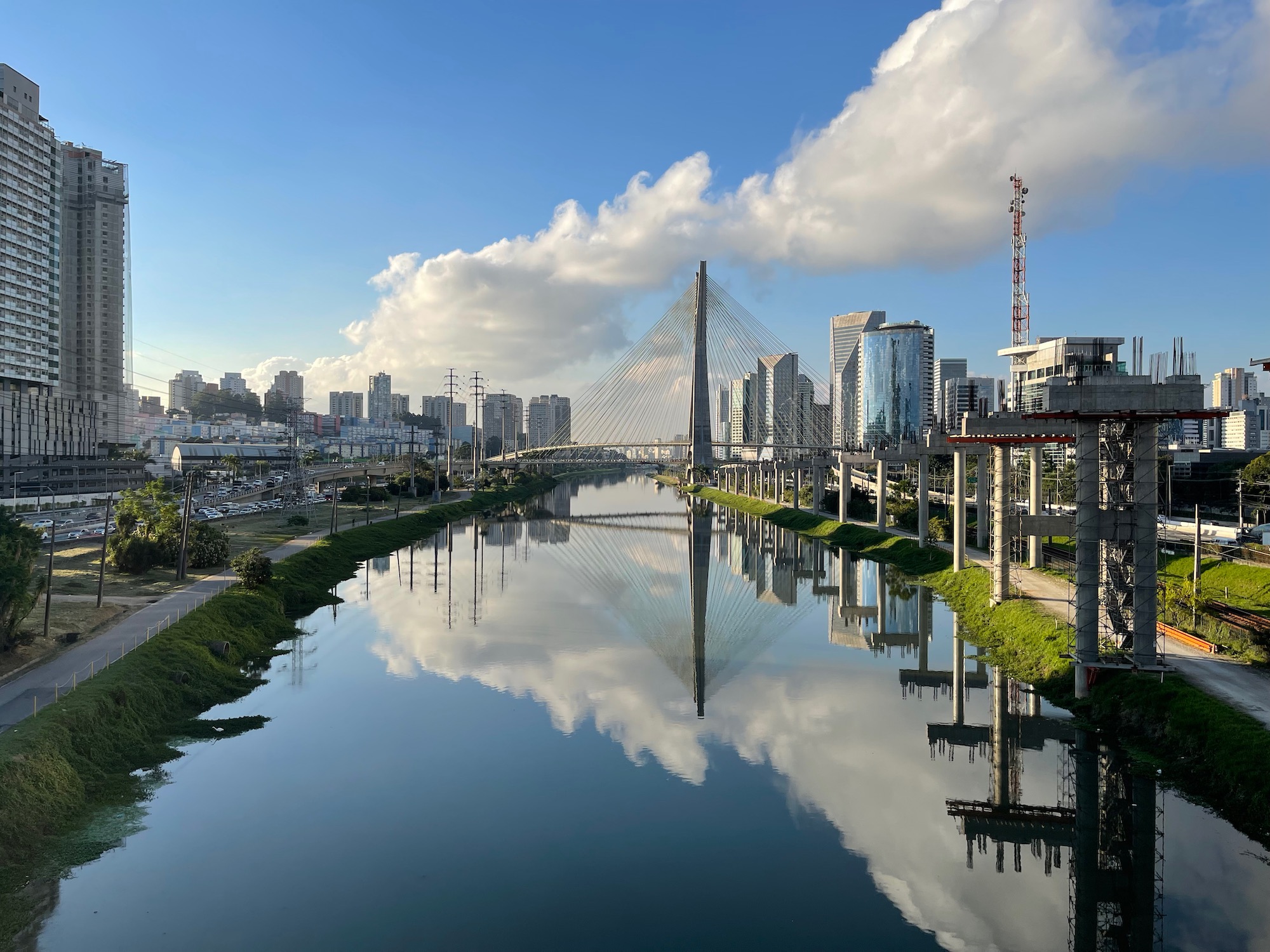 a river with a bridge and a city in the background