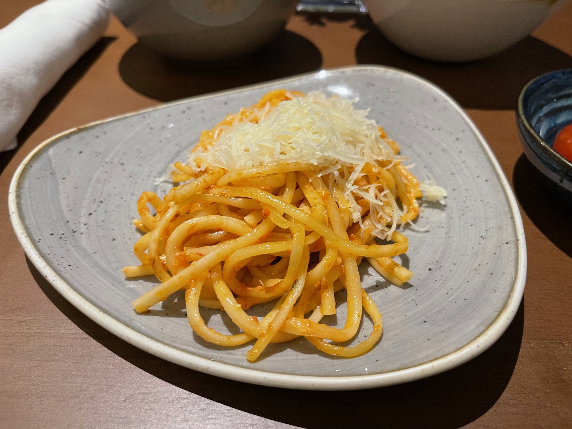 a plate of pasta with grated cheese