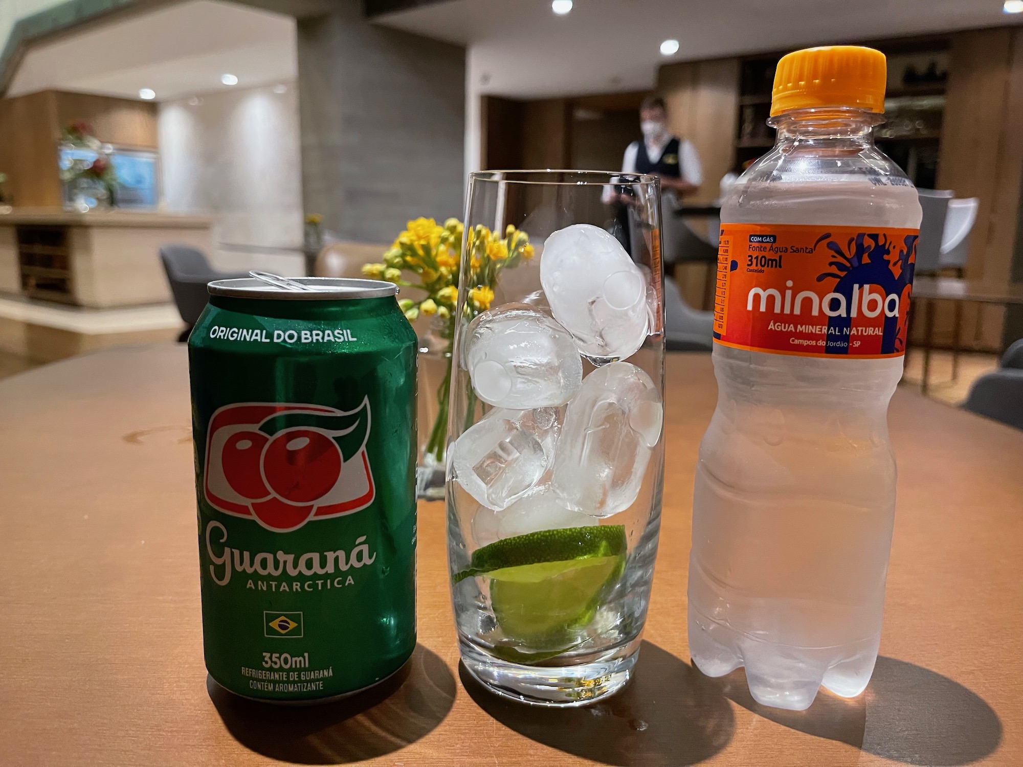 a drink and a glass of ice on a table