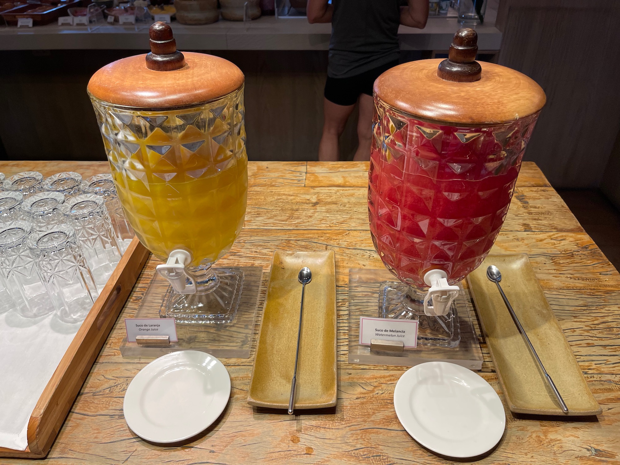 a couple of large glass containers with a wooden lid