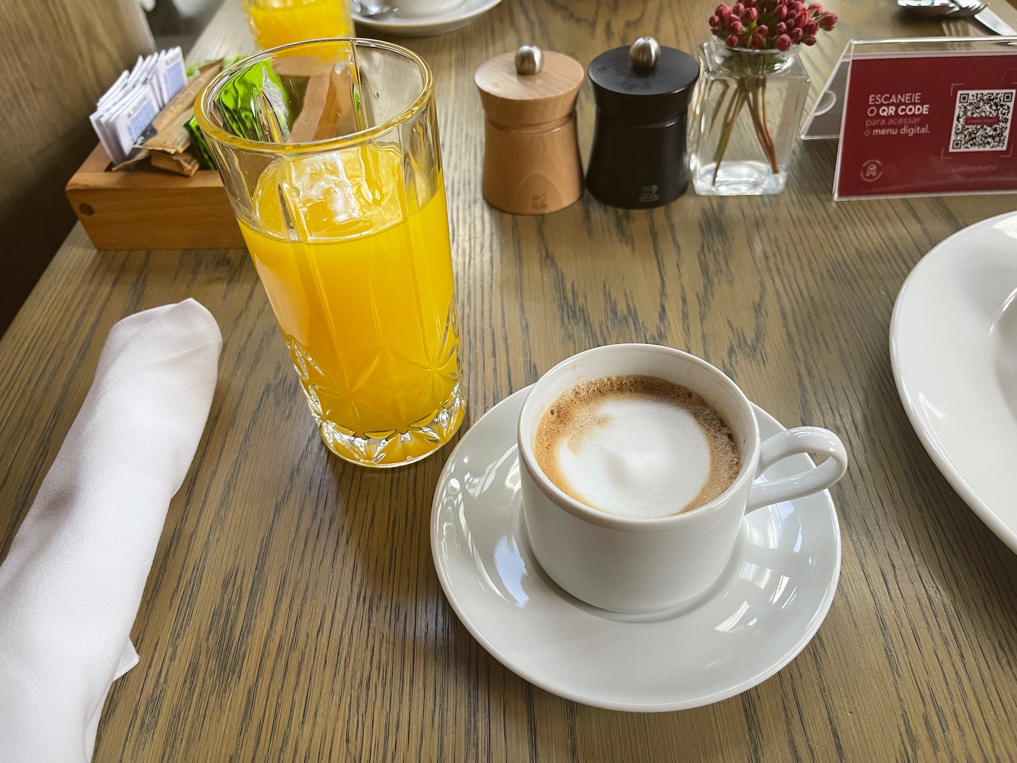 a cup of coffee and a glass of orange juice on a table