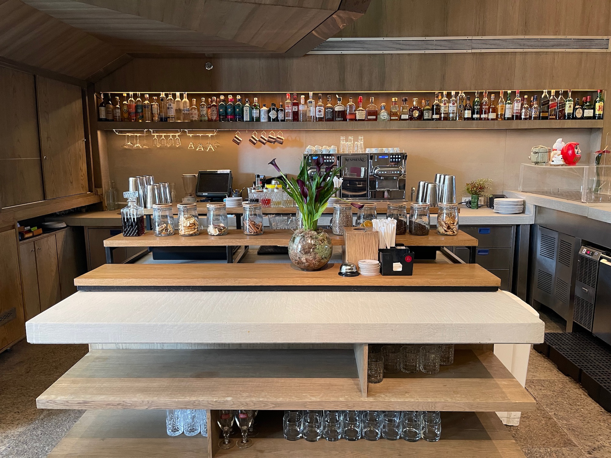 a bar with a variety of glasses and bottles