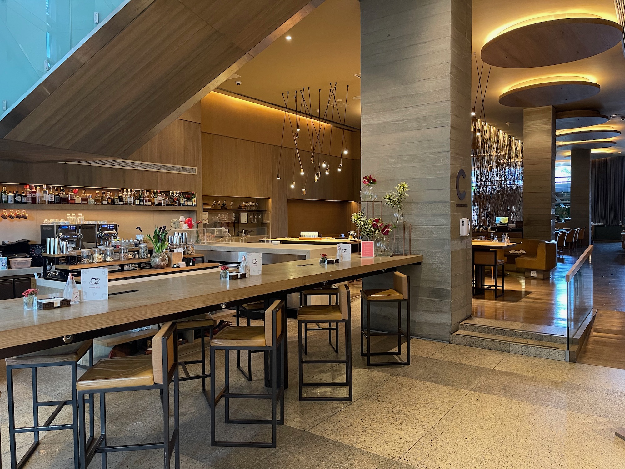 a bar with chairs and tables in a room