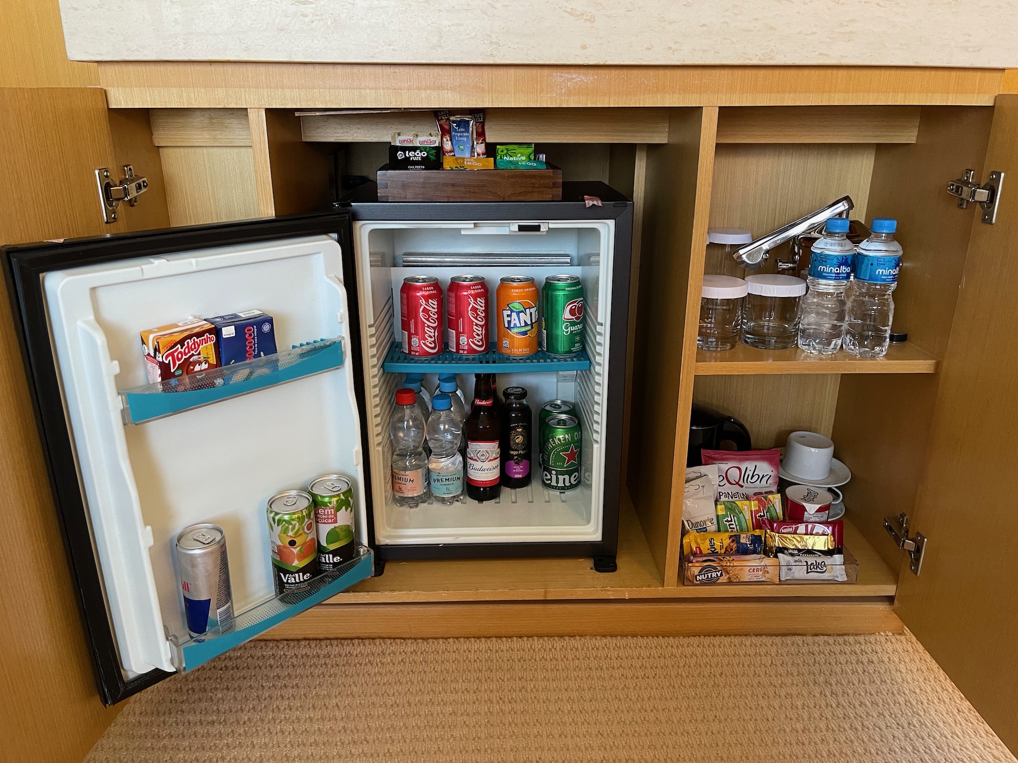 a mini fridge with drinks and snacks inside