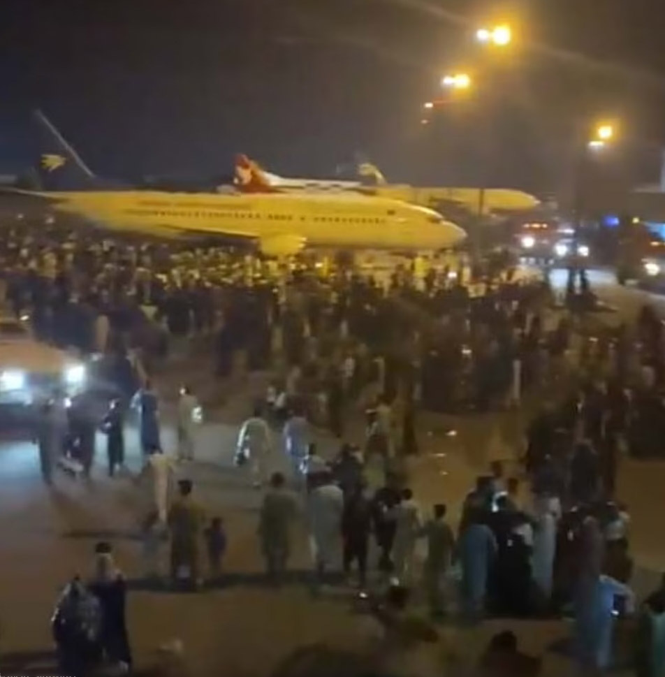 a group of people standing around airplanes