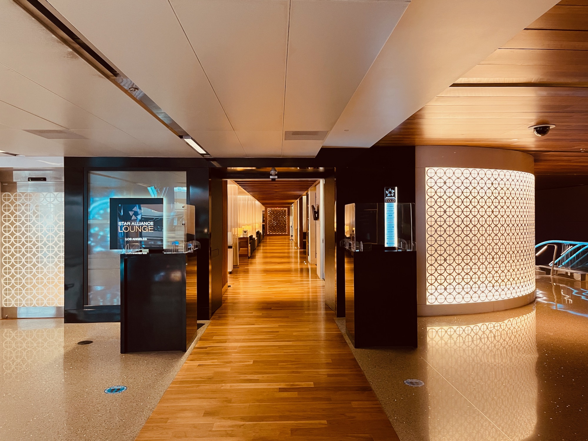 a hallway with a wood floor and a light fixture