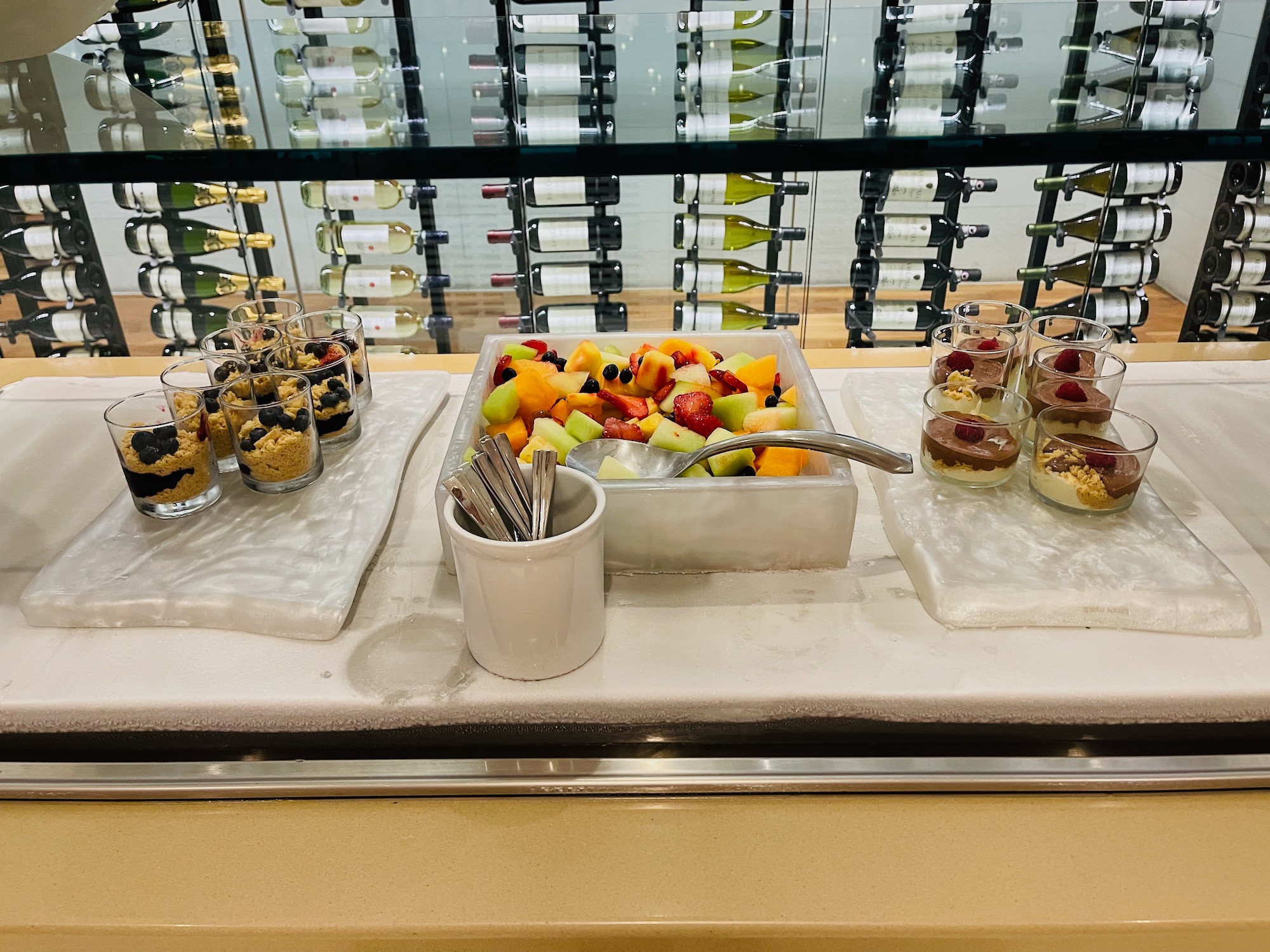 a table with food in cups and utensils