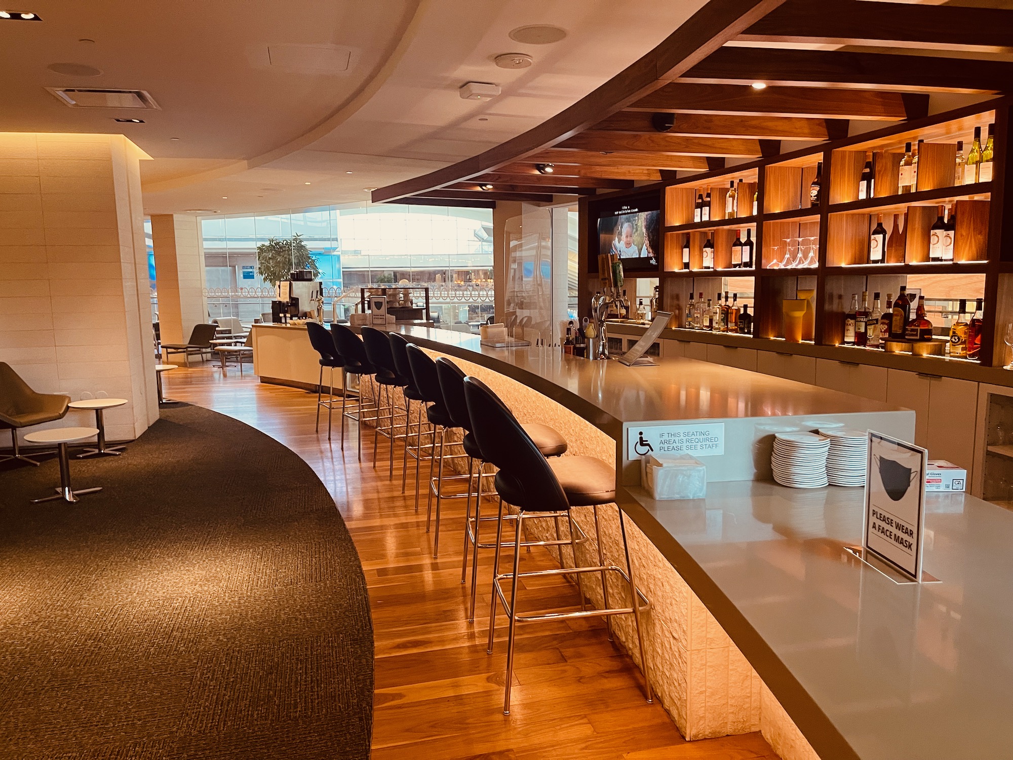 a bar with chairs and shelves in a room