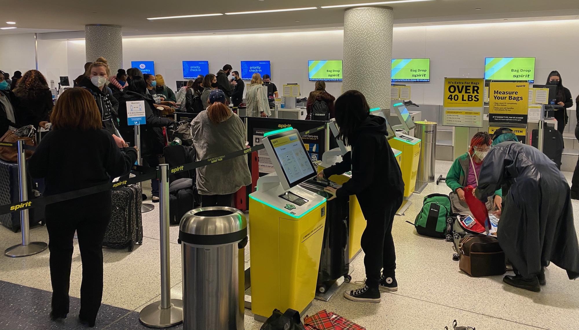 a group of people at an airport check in counters