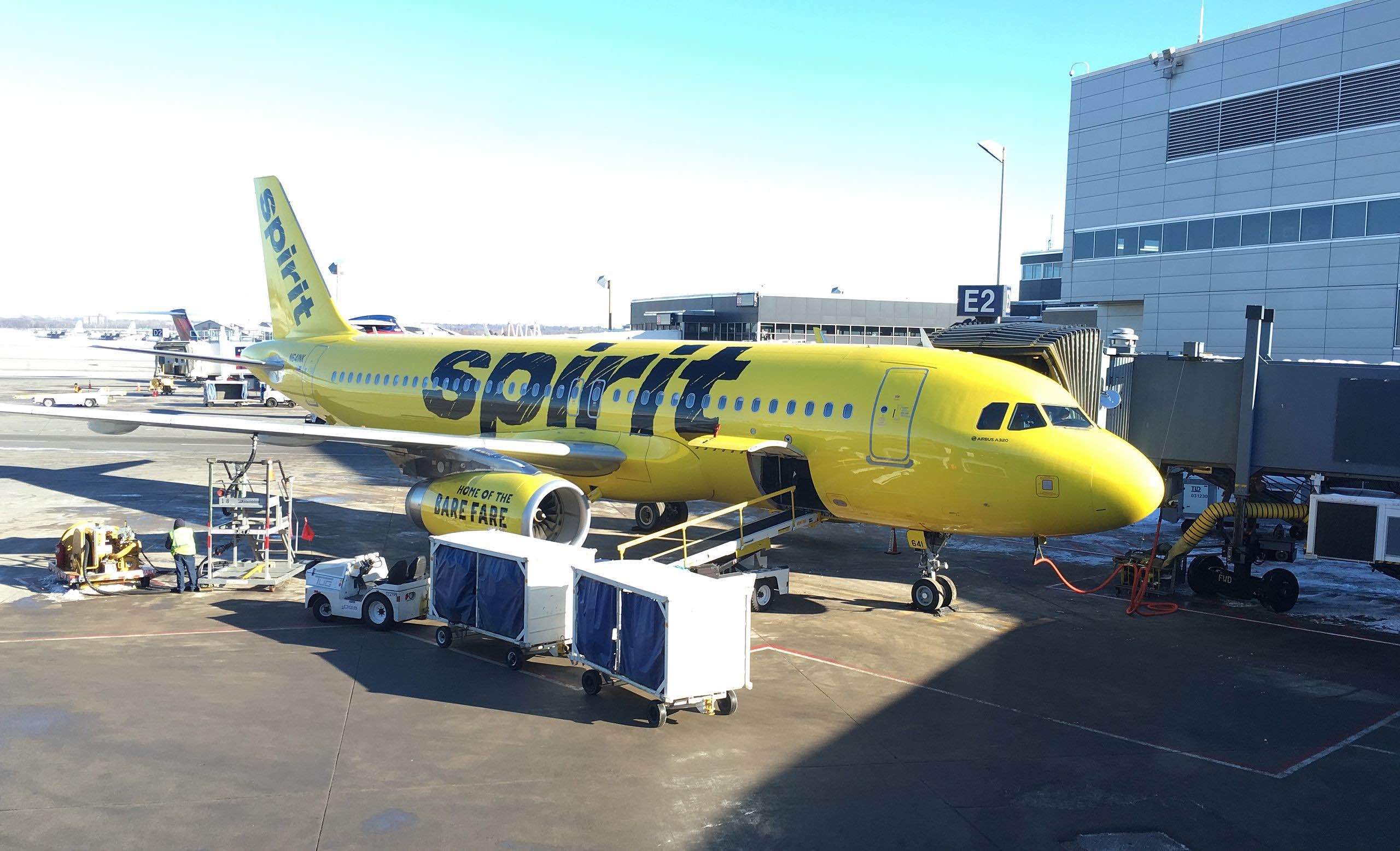 a yellow airplane at an airport