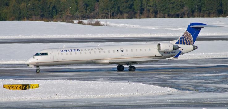 a plane on a runway in the snow