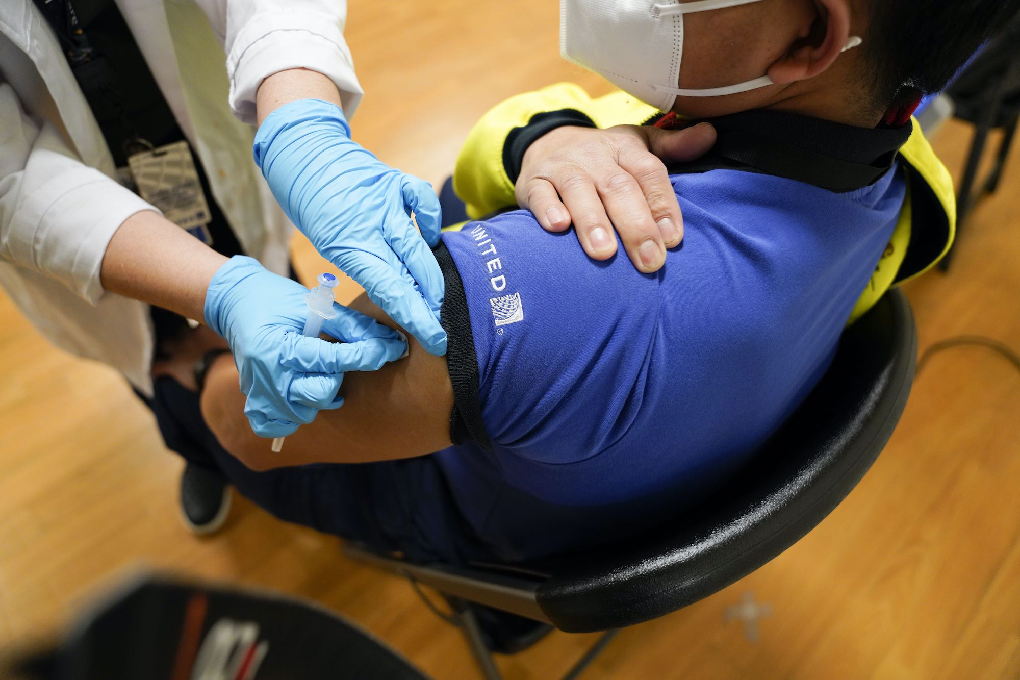 a person injecting a person's arm