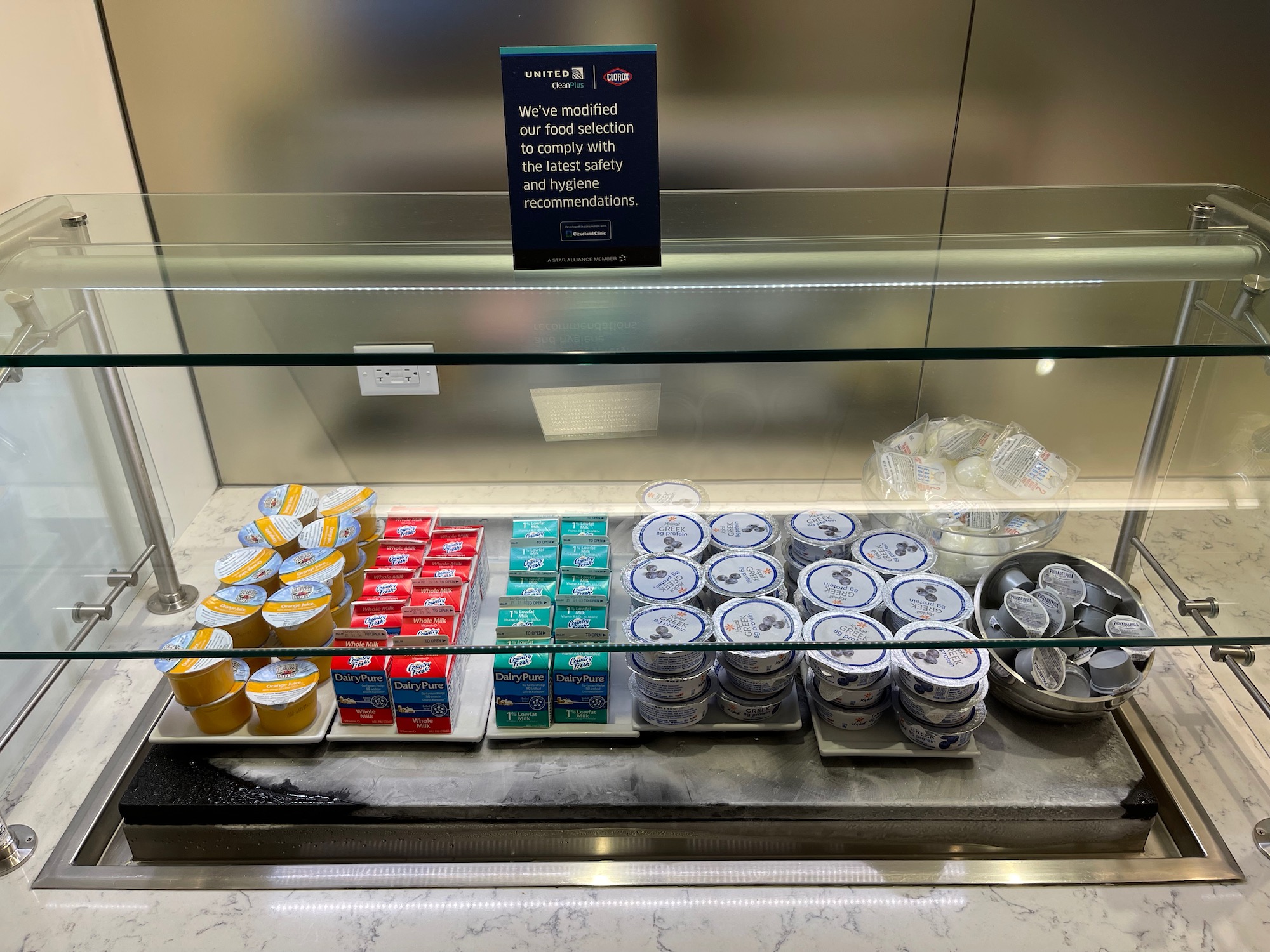 a display case with different types of yogurt and other food items