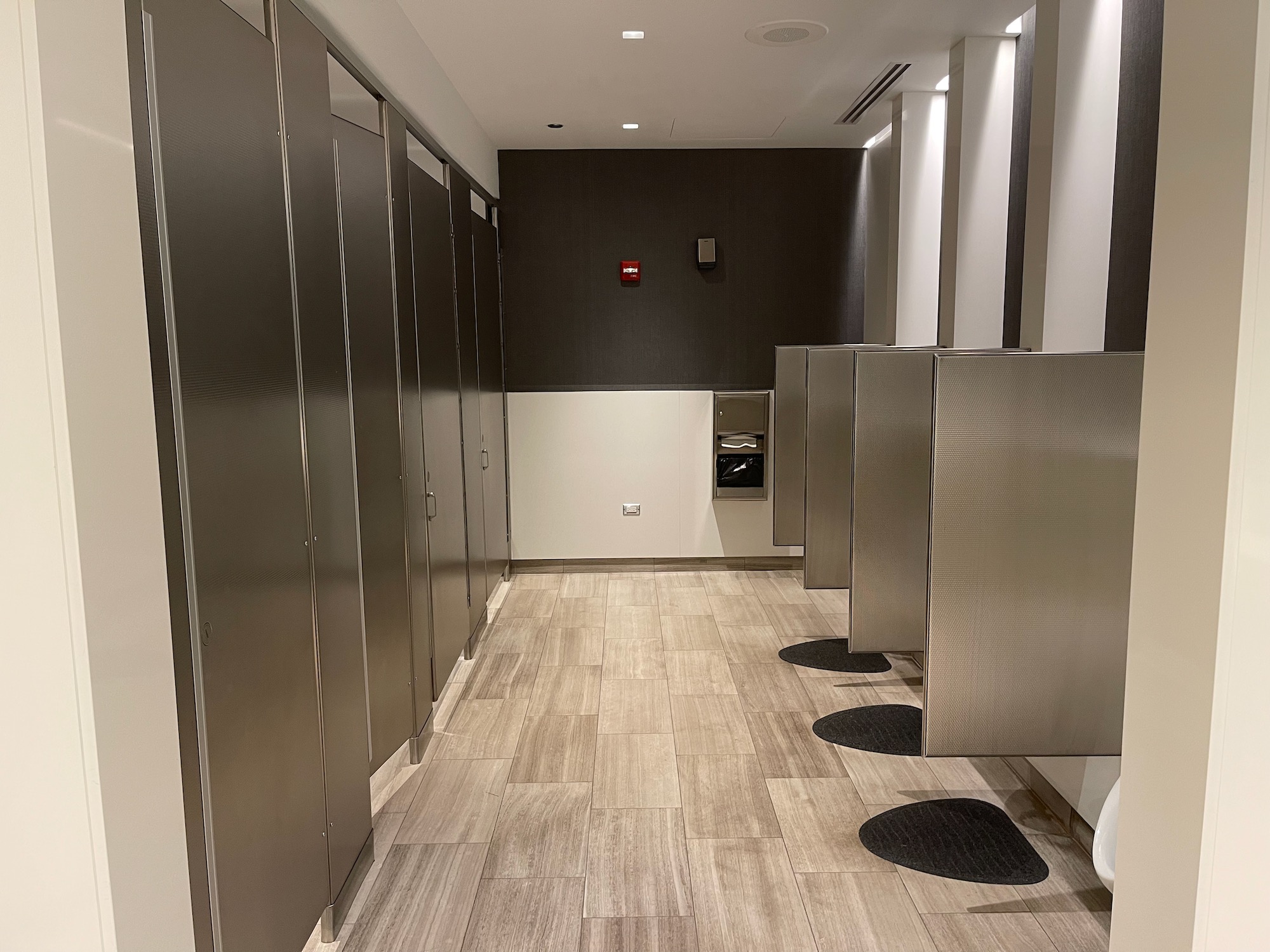 a row of metal doors in a bathroom