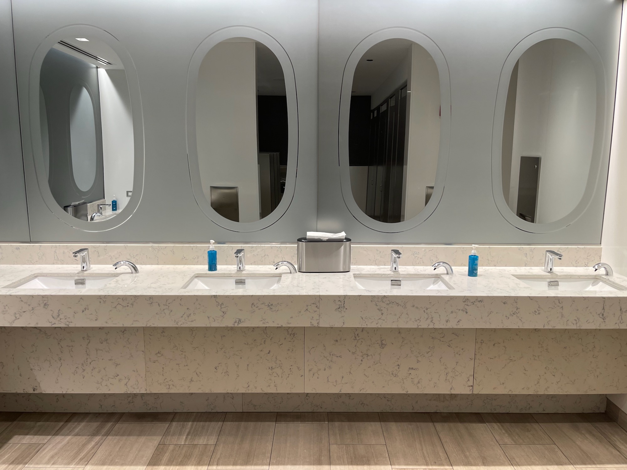 a bathroom with sinks and mirrors