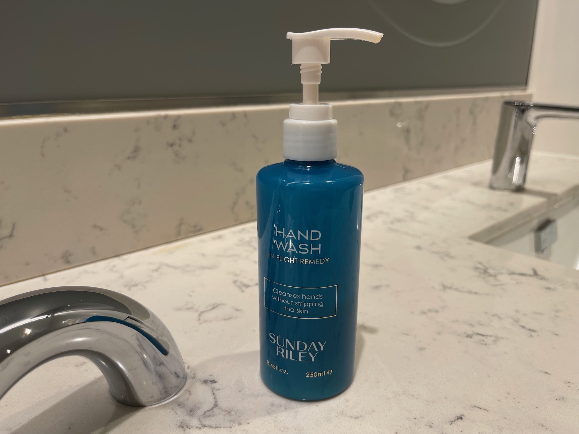 a blue bottle of hand wash on a counter