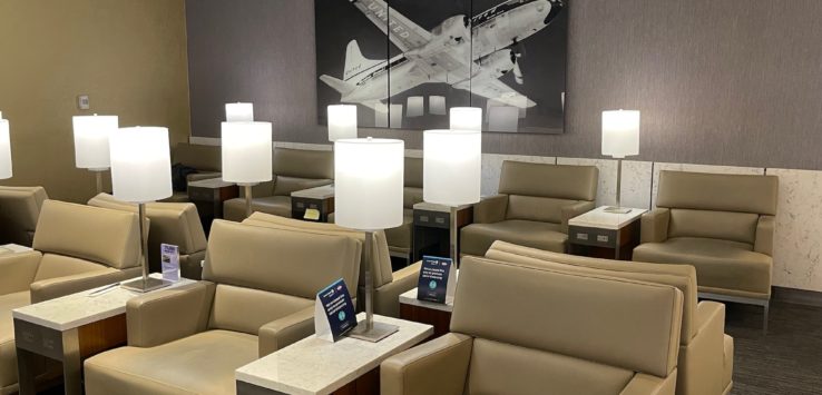 a room with chairs and a picture of an airplane