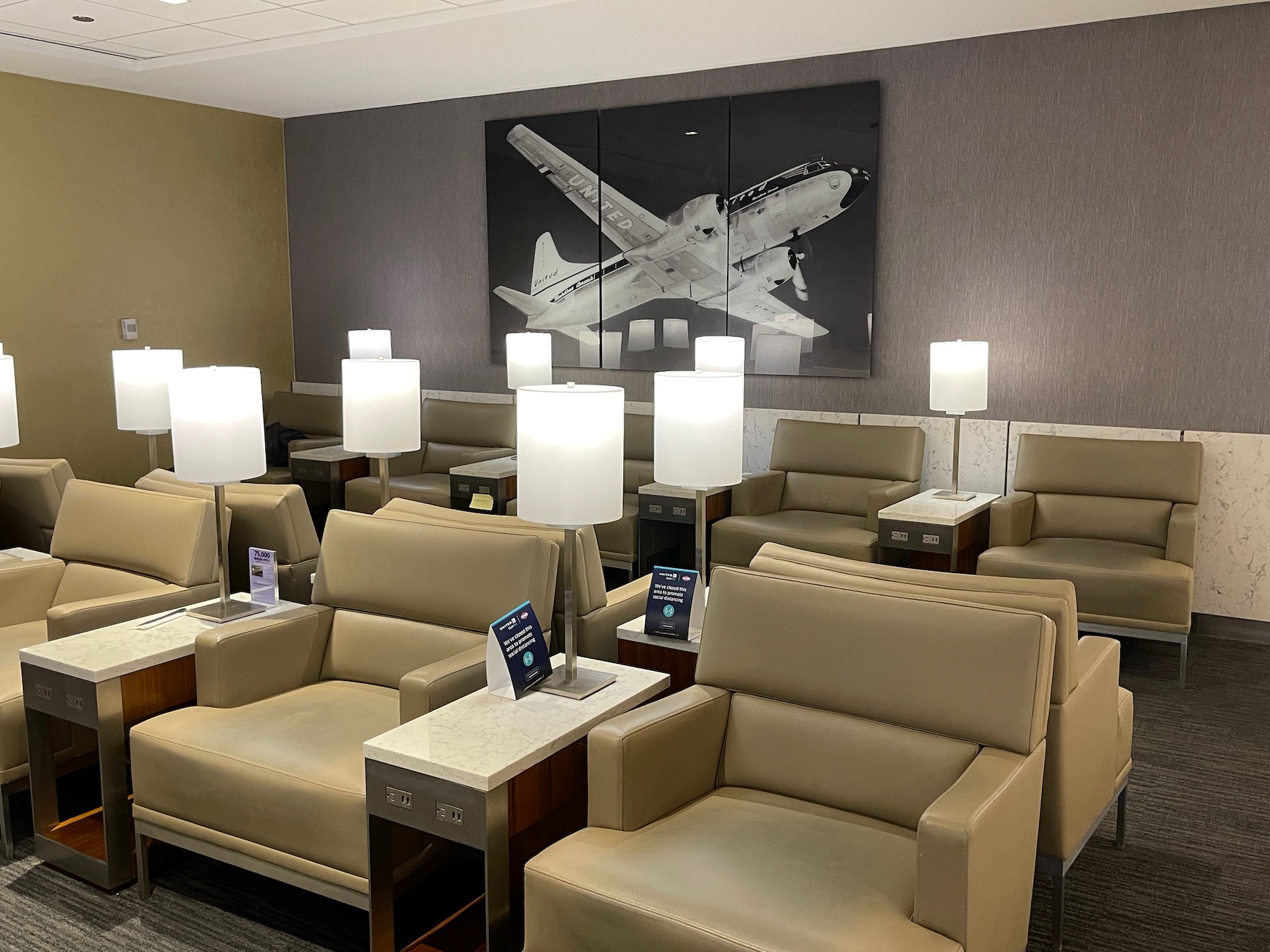 a room with chairs and a picture of an airplane