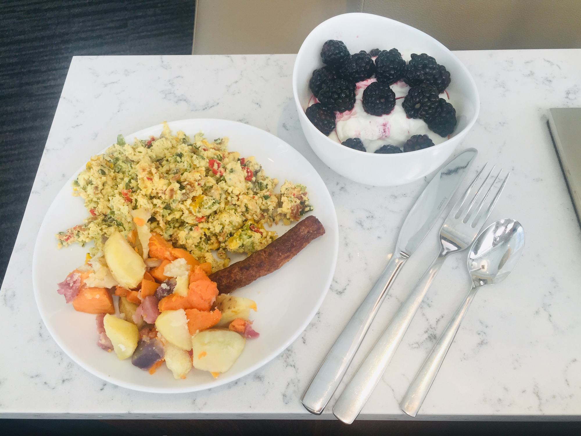 a plate of food and a bowl of fruit