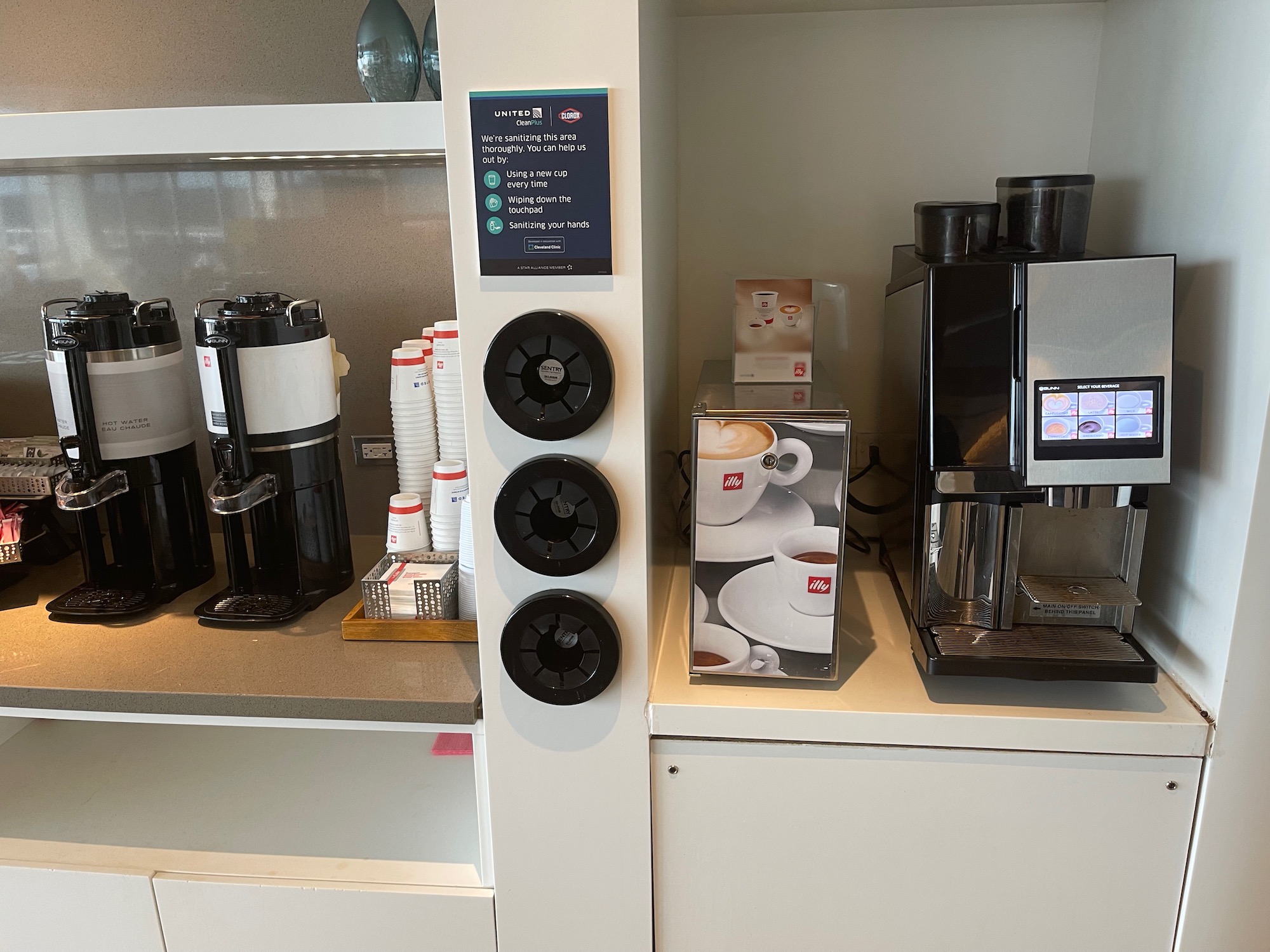 a coffee machine and coffee cups on a counter