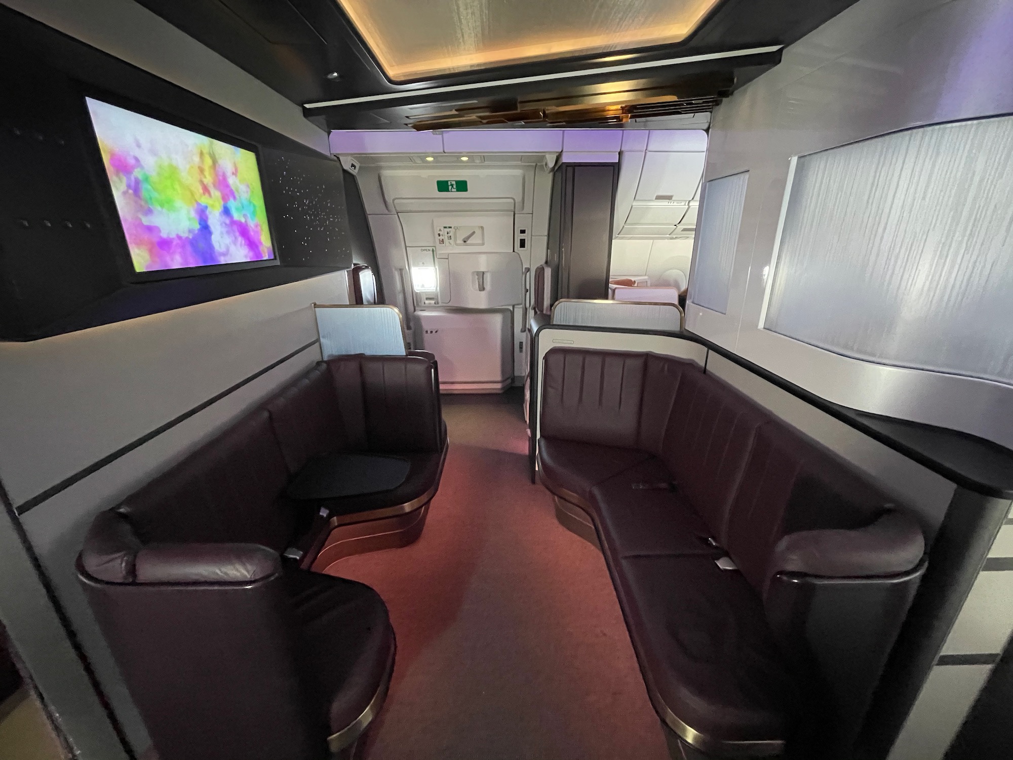 a inside of a plane with a couch and a television