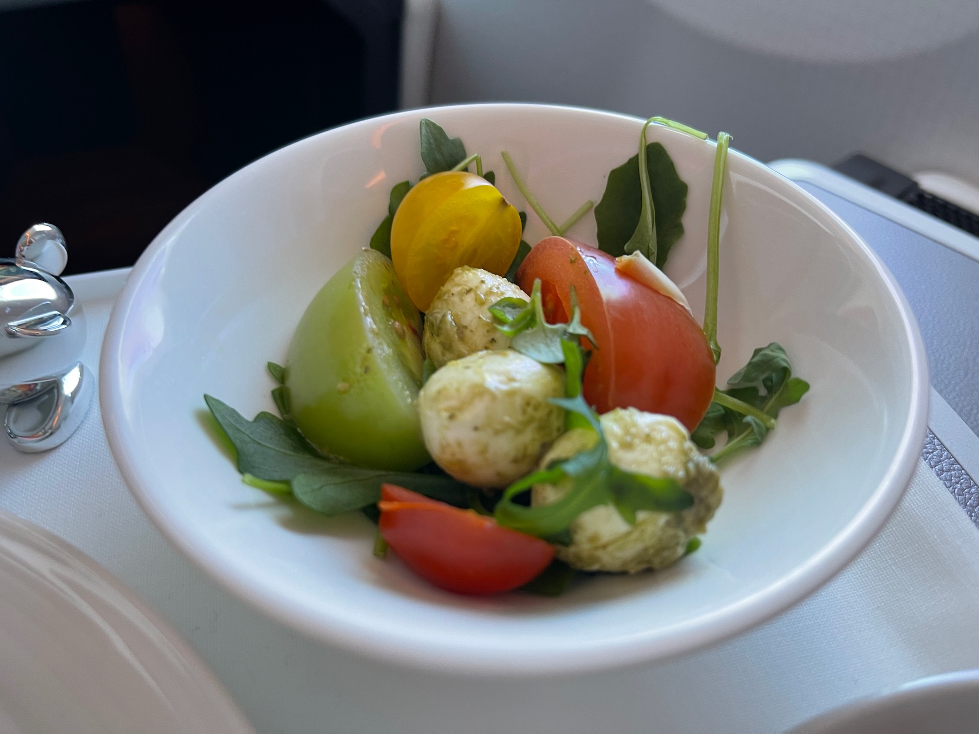 a bowl of salad with tomatoes and cheese