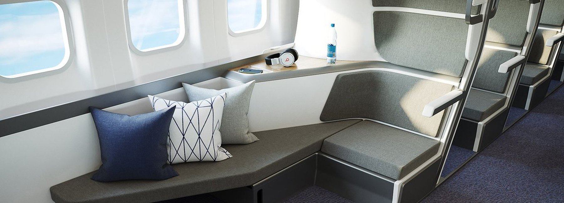 a seat with pillows and a bottle of water on the side