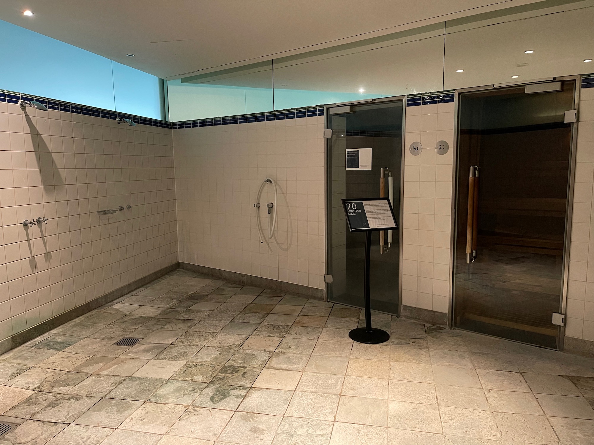 a shower room with a sign and a shower door