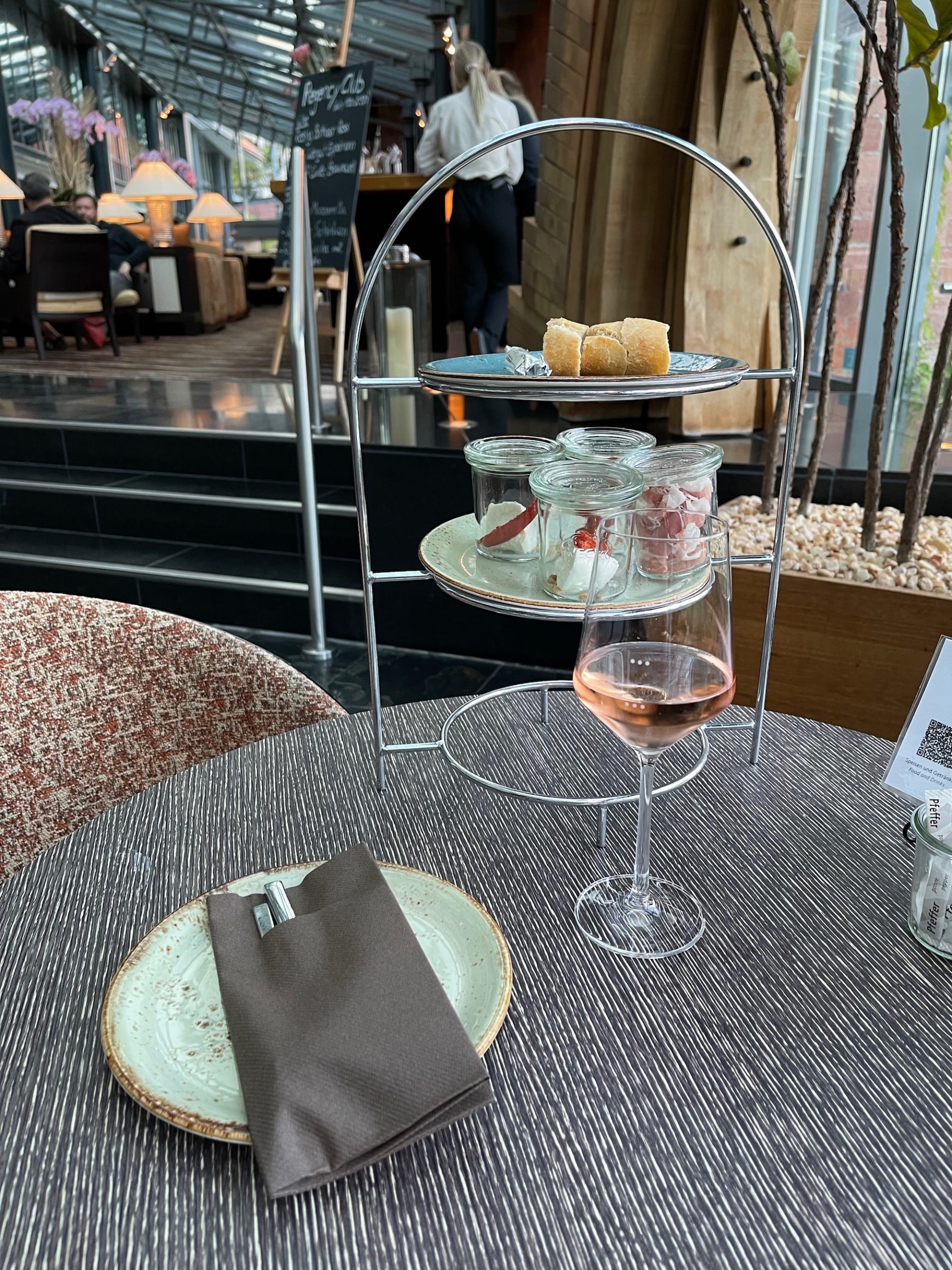 a table with a glass of wine and food on it