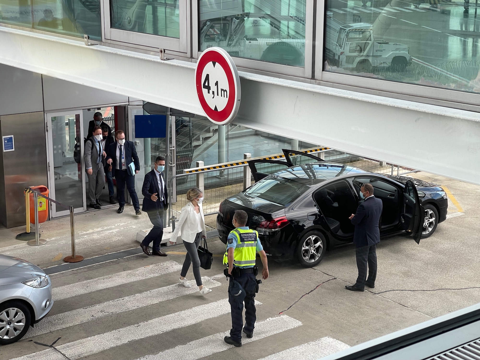 people standing in front of a black car