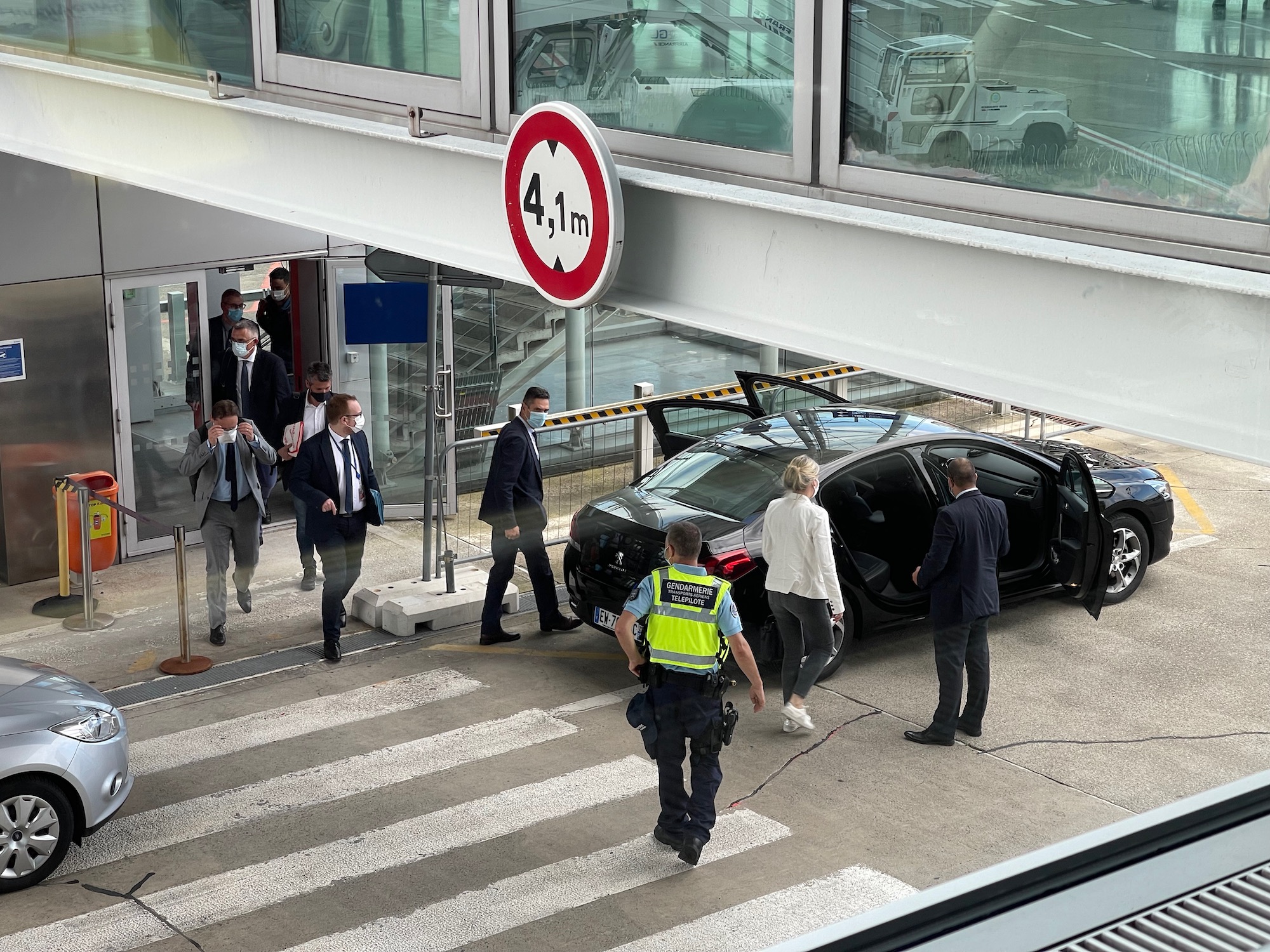 a group of people standing around a car