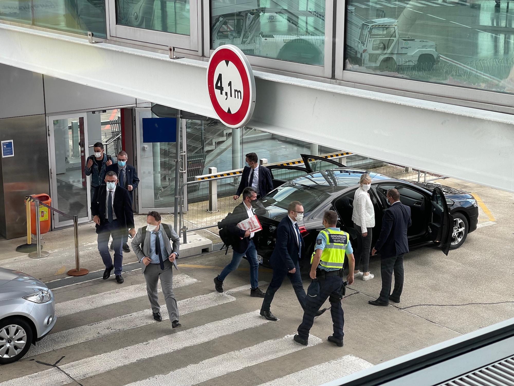 a group of people walking in front of a building