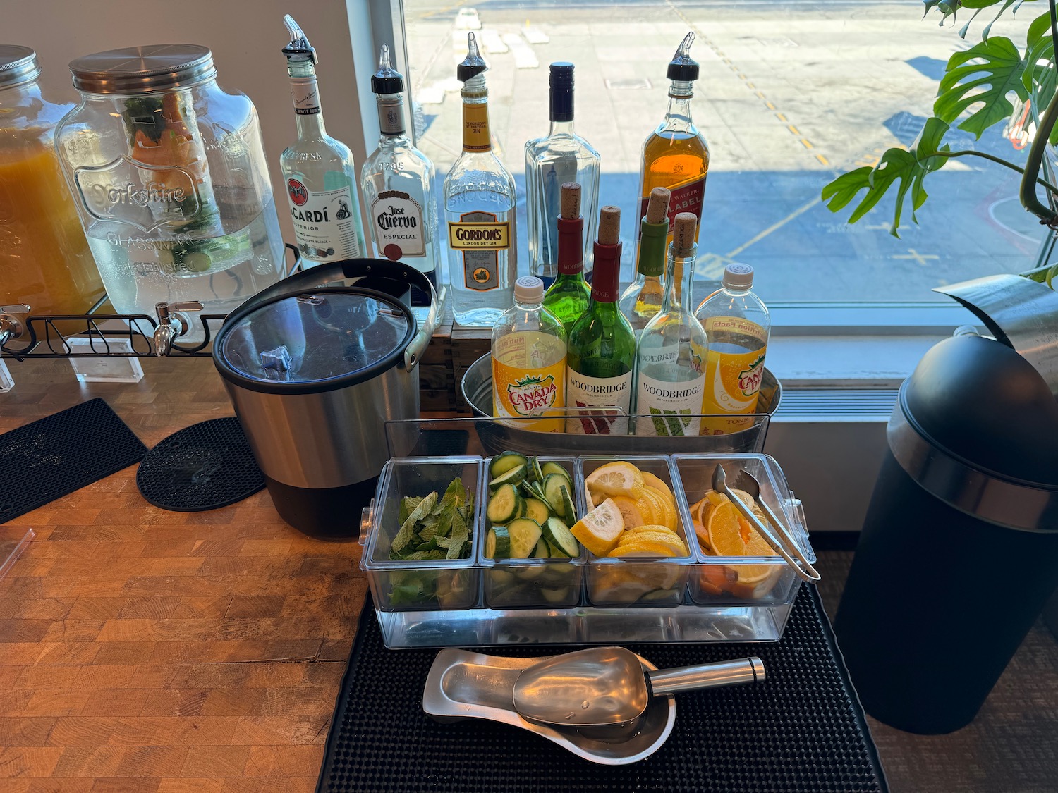 a group of bottles of alcohol and a container of fruit