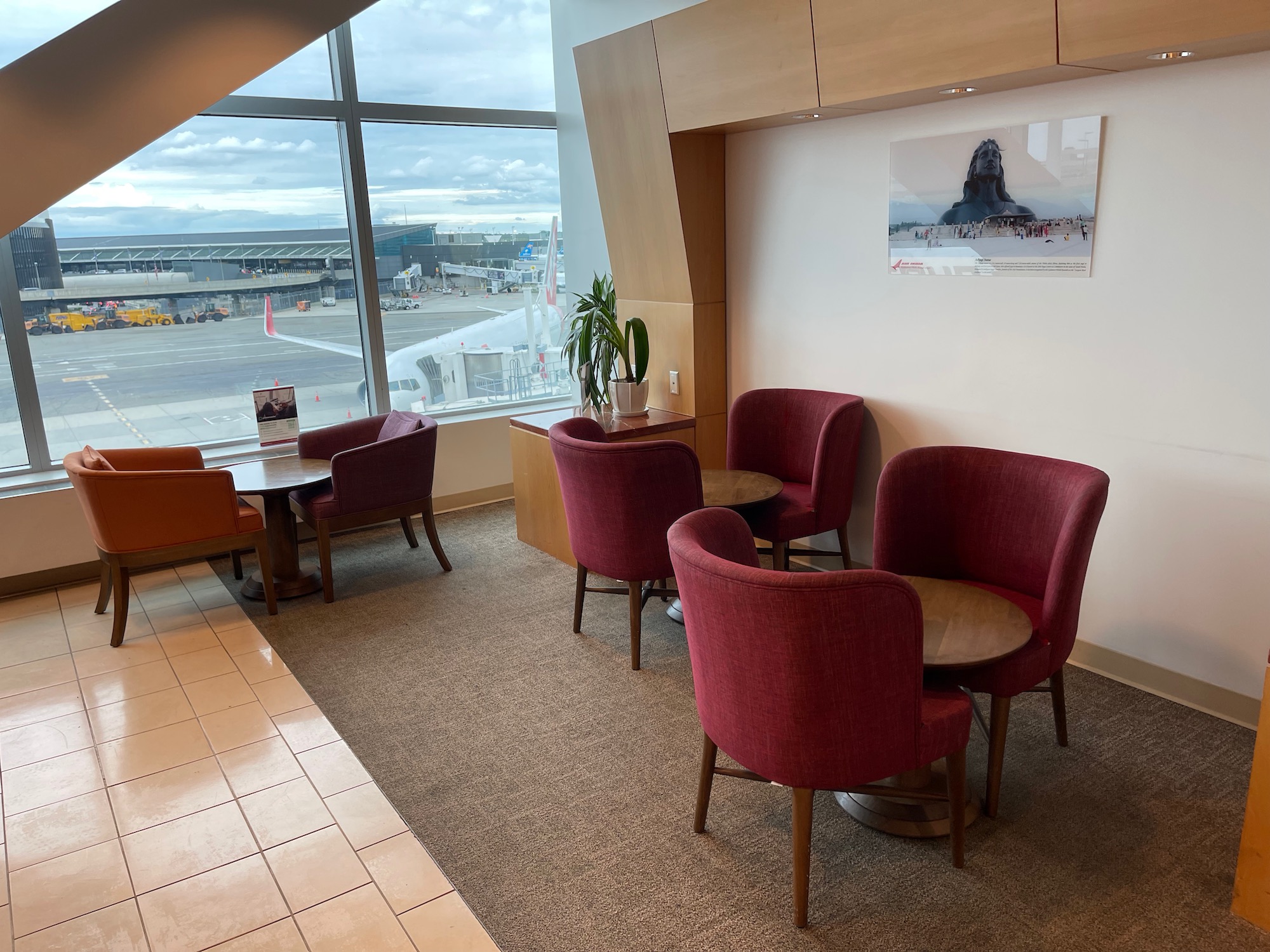 a room with chairs and tables and a window