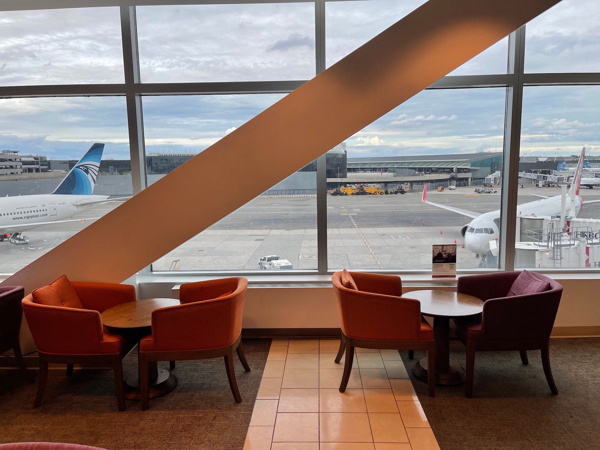 a room with chairs and tables and a window