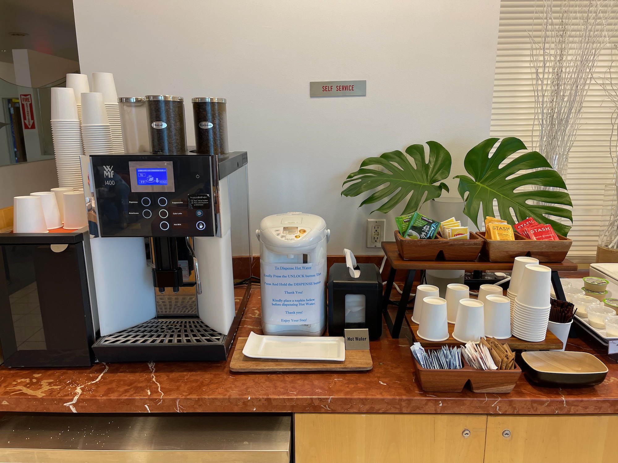 a coffee machine and cups on a counter