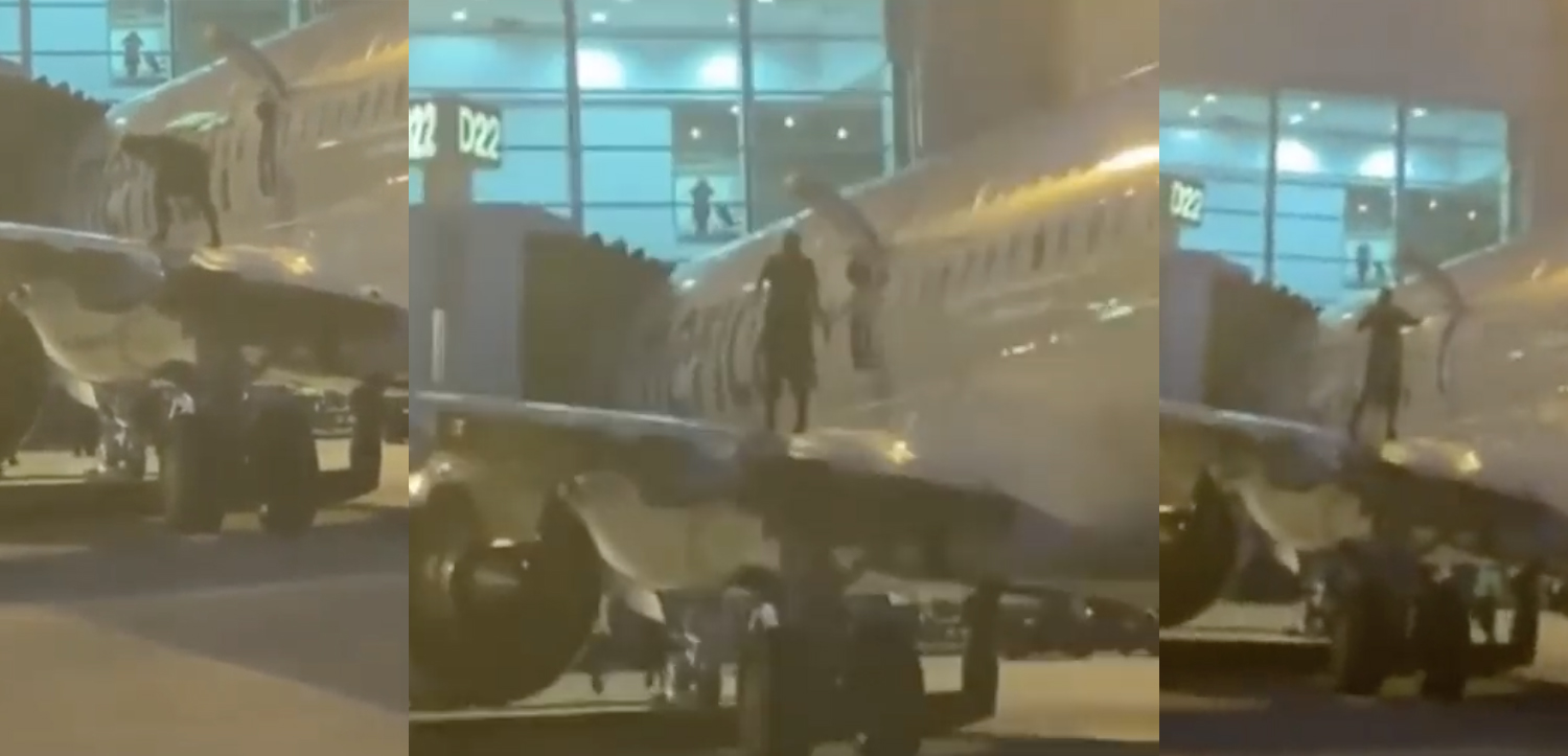 a person standing on the side of a plane