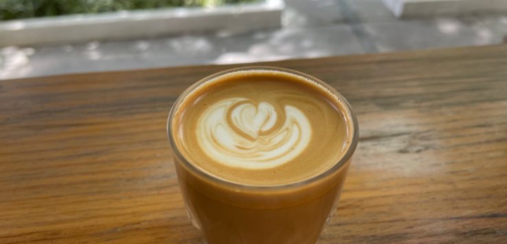 a glass of coffee on a table