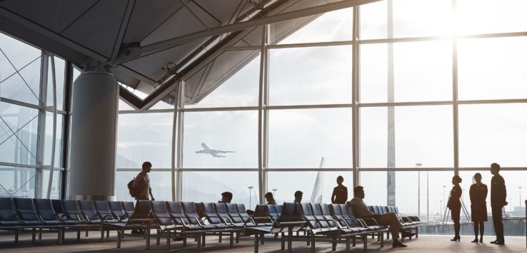 people sitting in chairs in an airport