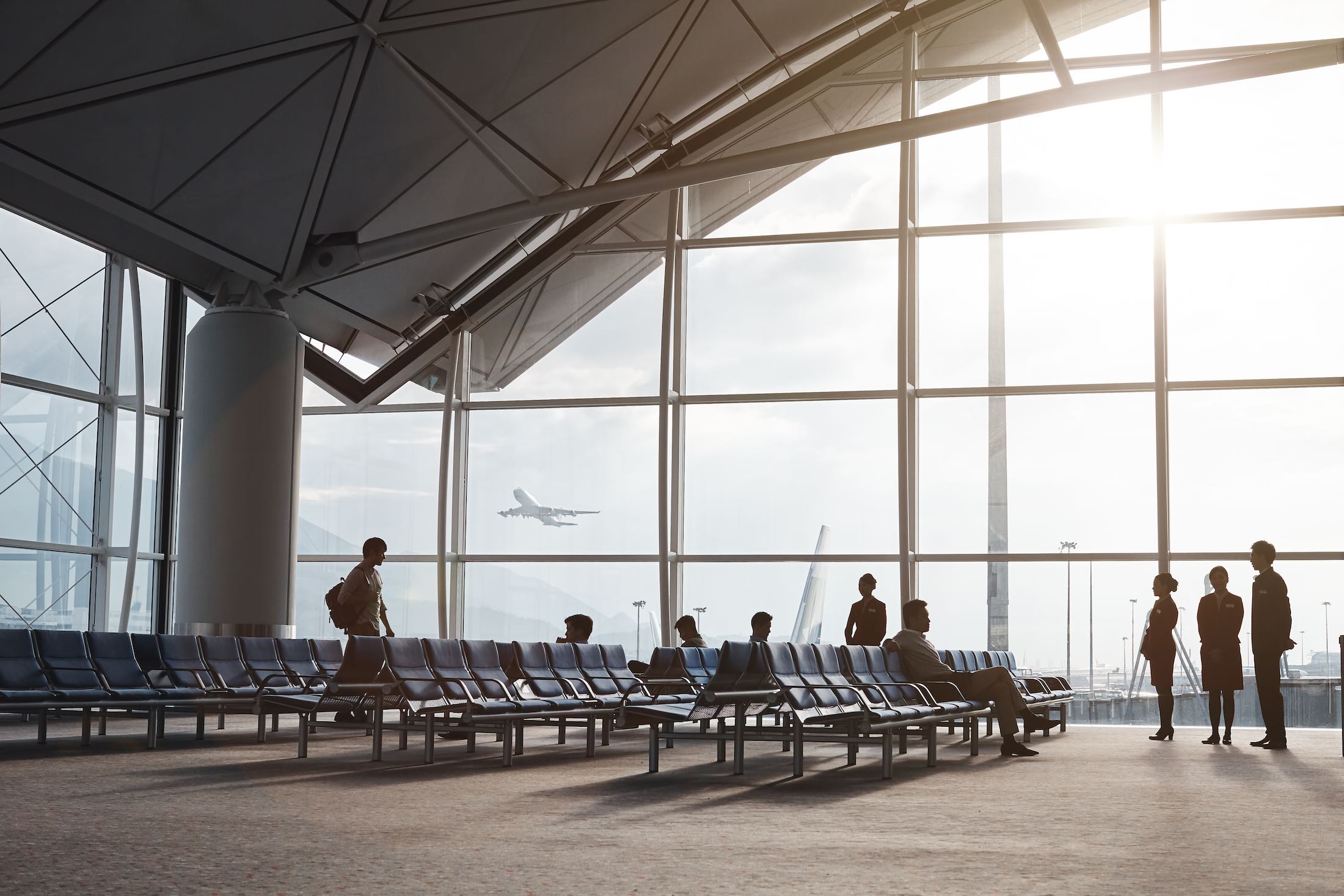 people sitting in chairs in an airport