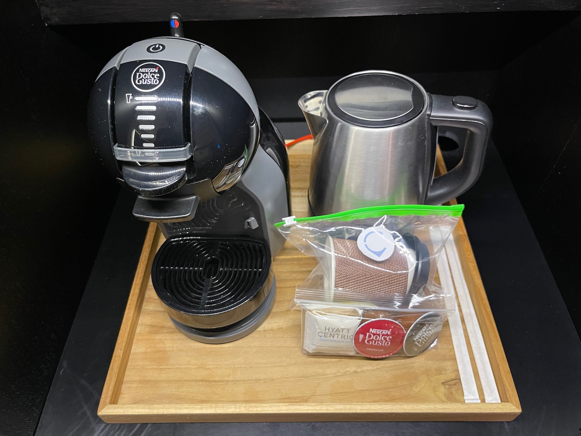 a coffee maker and a kettle on a tray