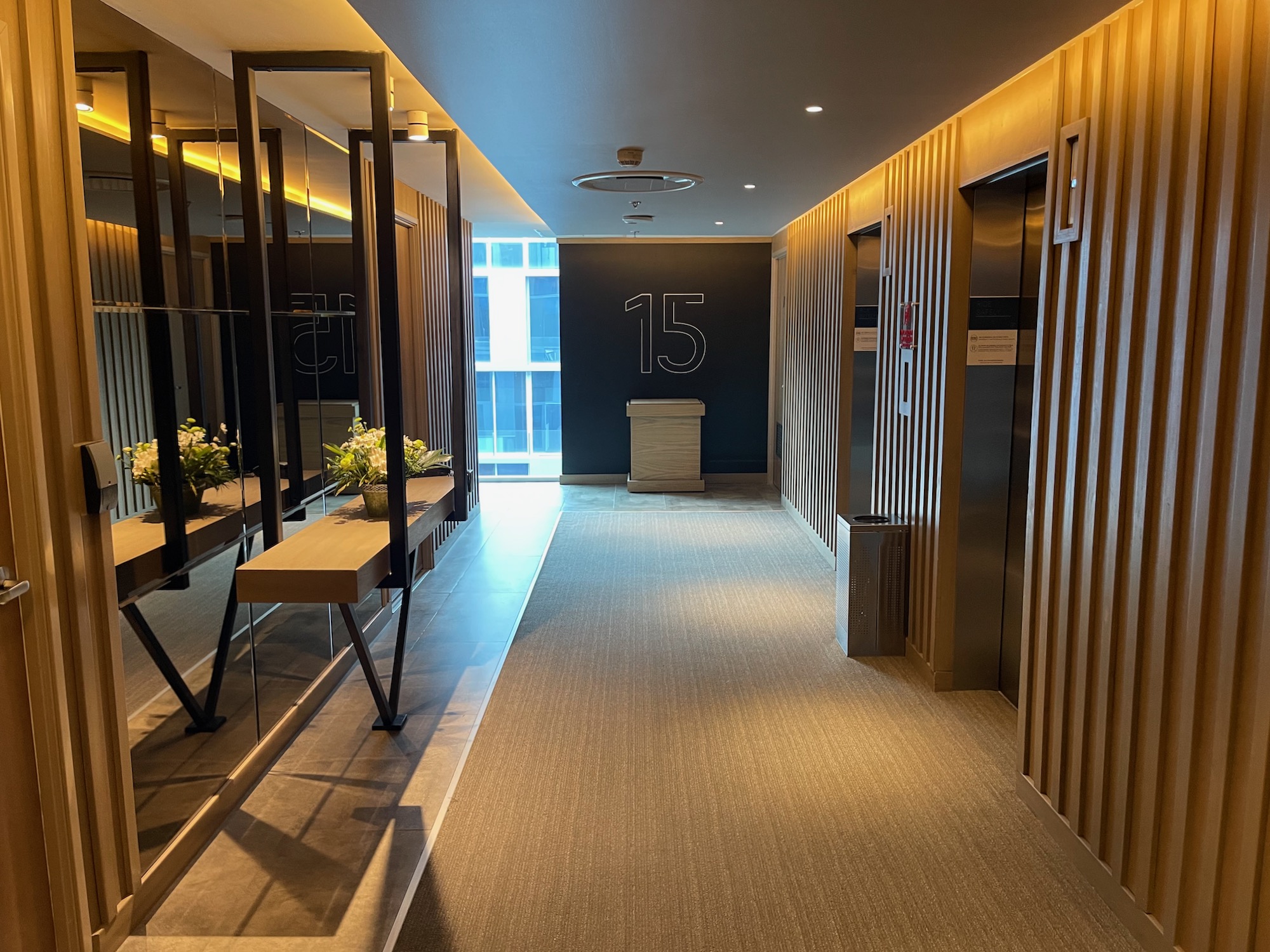 a hallway with elevator doors and a table