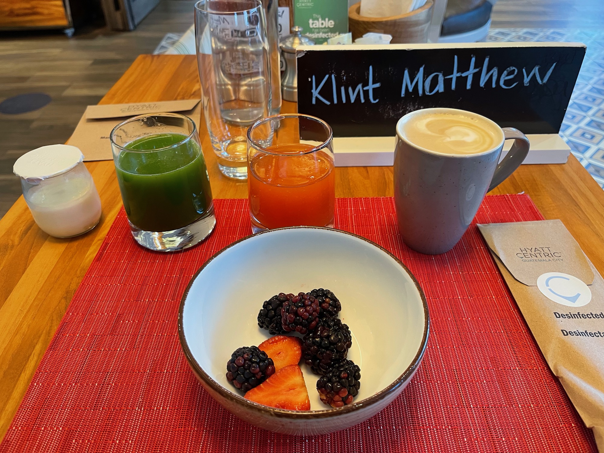 a bowl of fruit and juice on a table