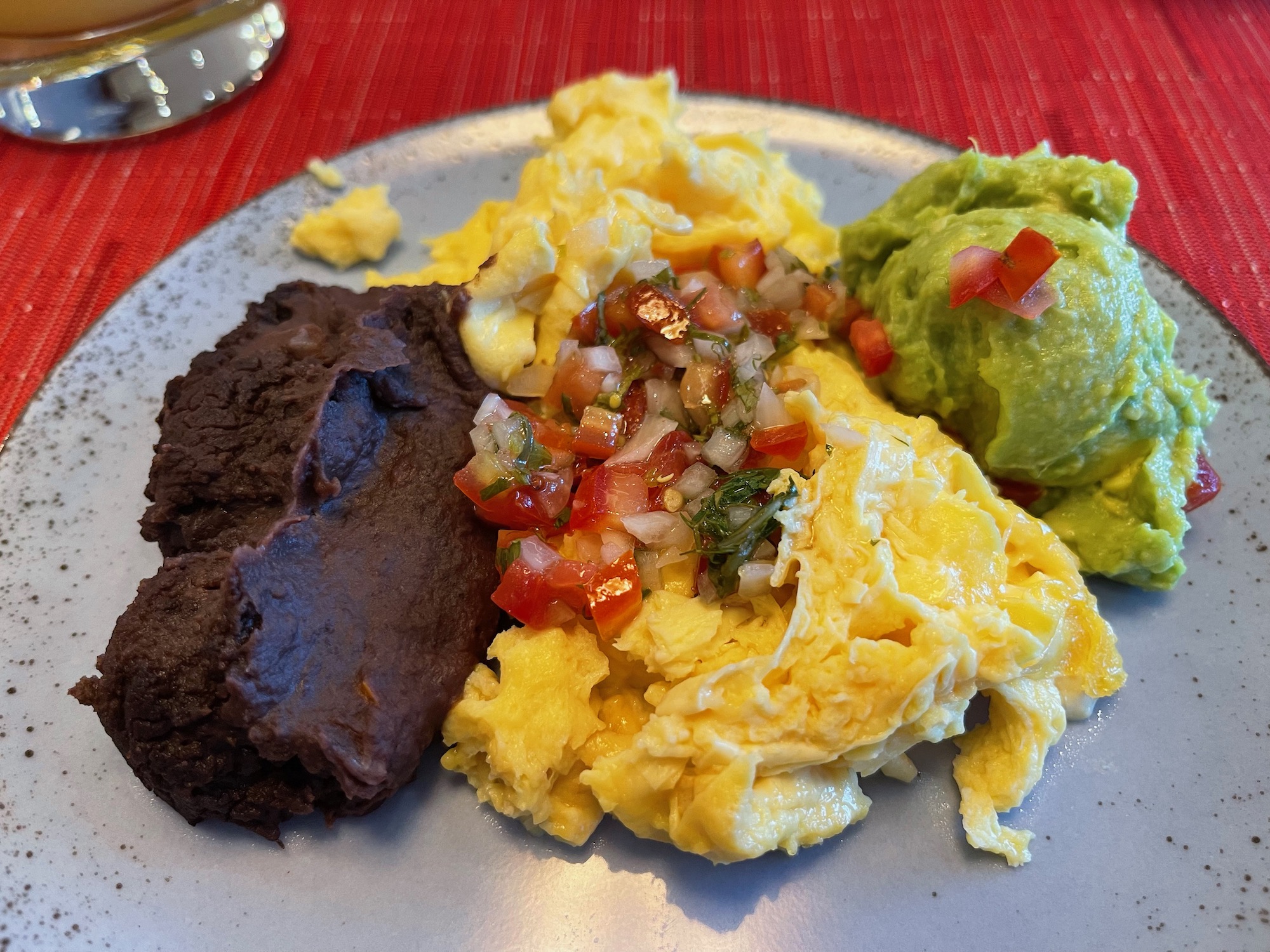a plate of scrambled eggs and salsa