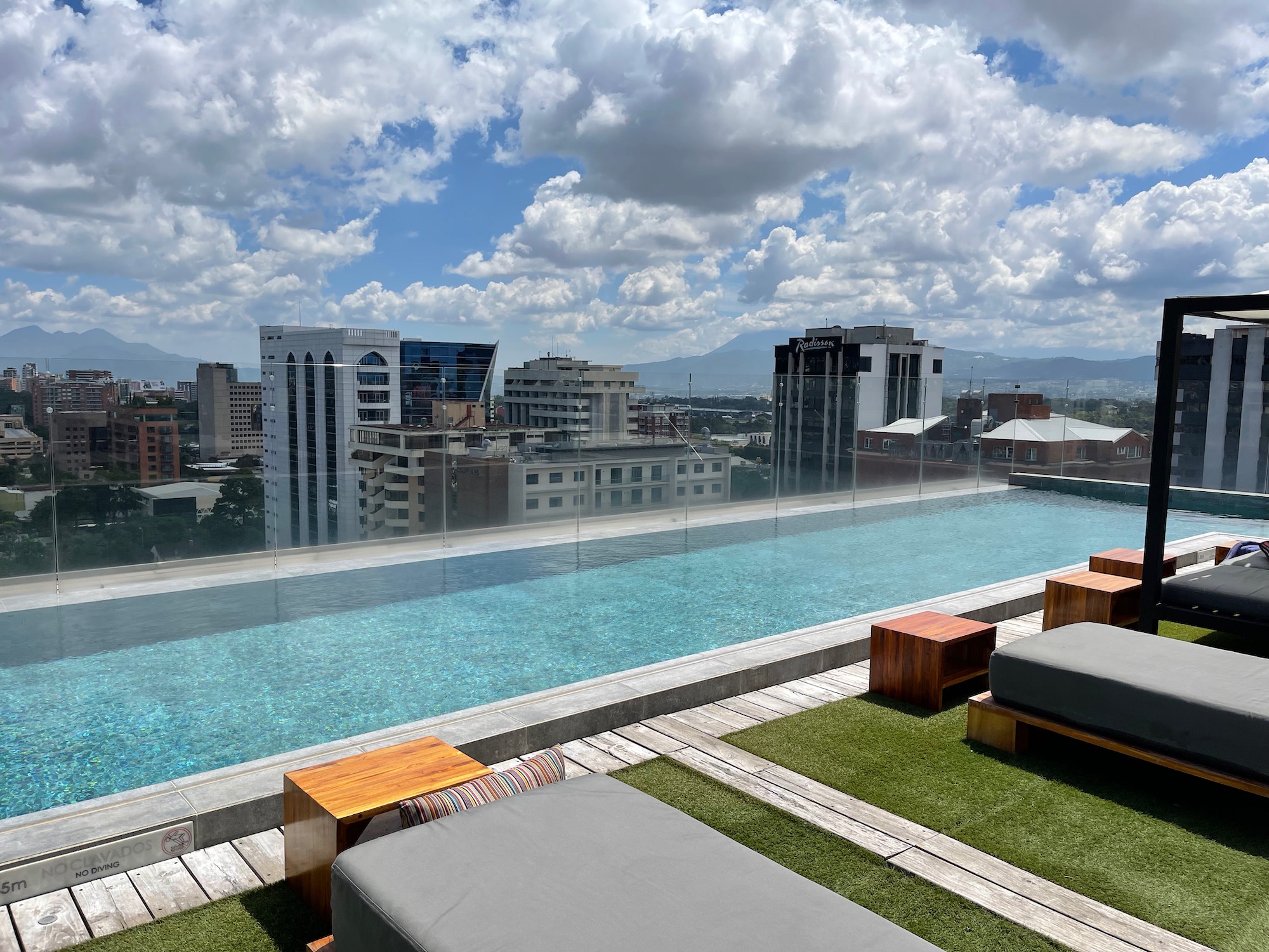 a pool with a view of a city and mountains