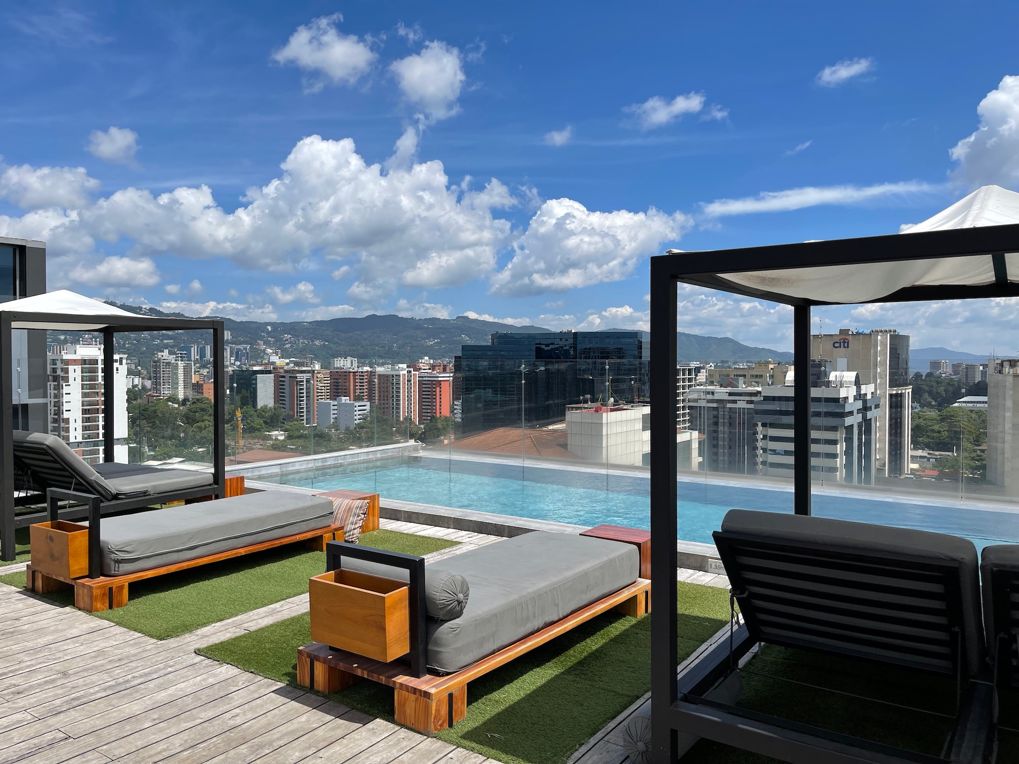 a pool with a view of a city and a city in the background