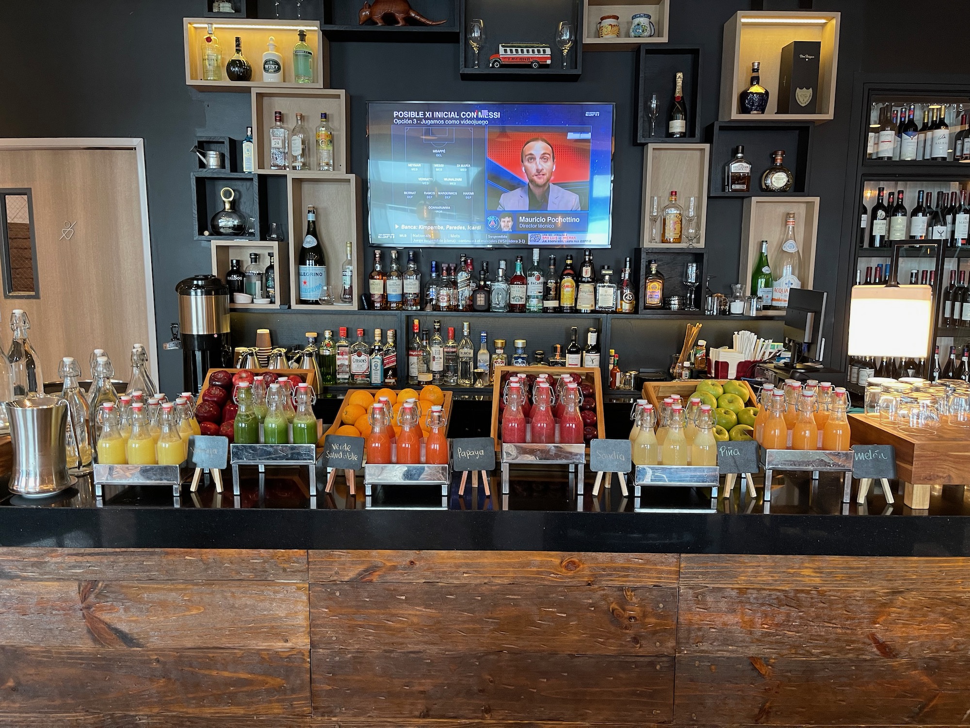 a bar with bottles of juice and a television