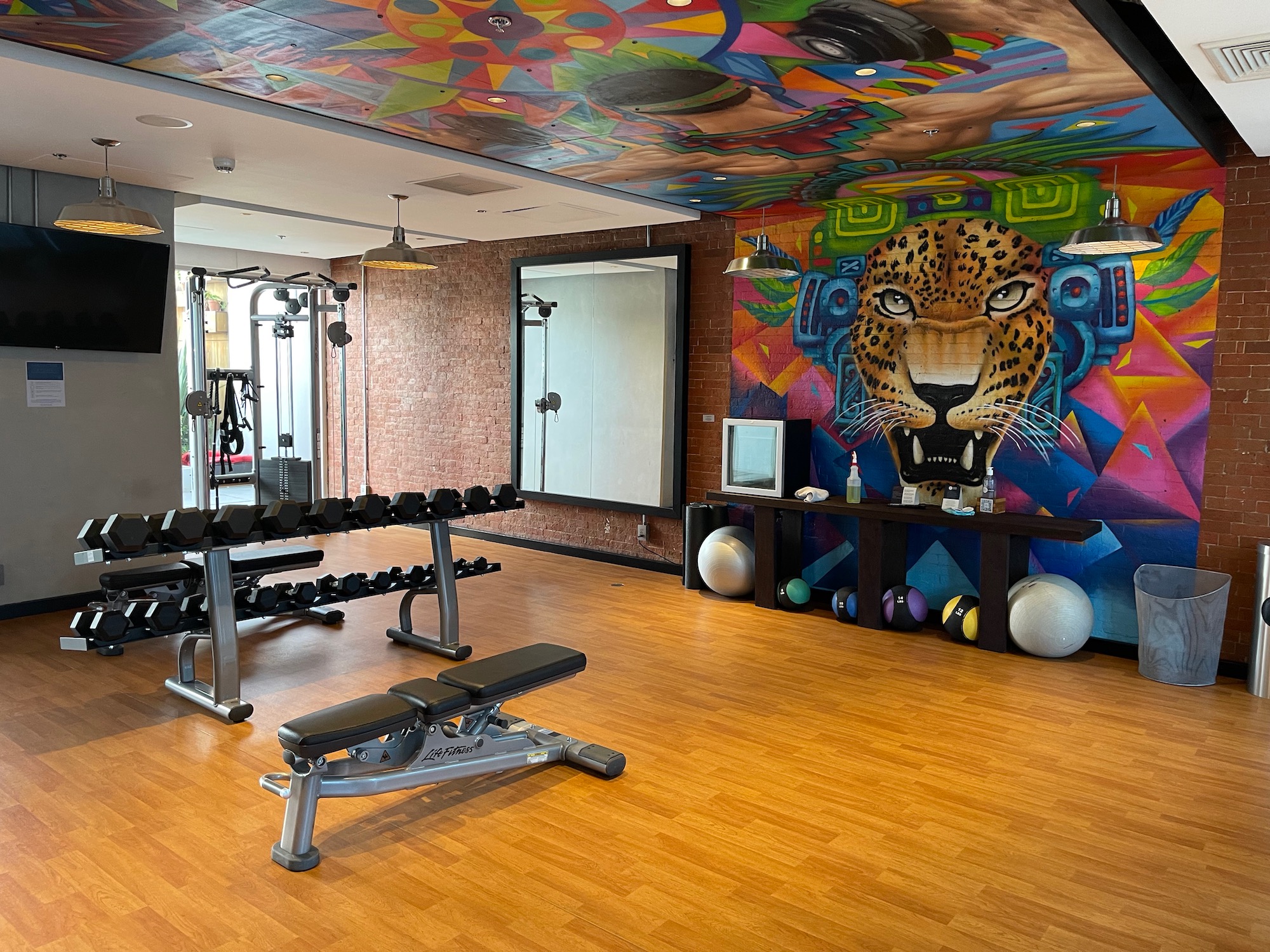 a gym with a painting on the wall