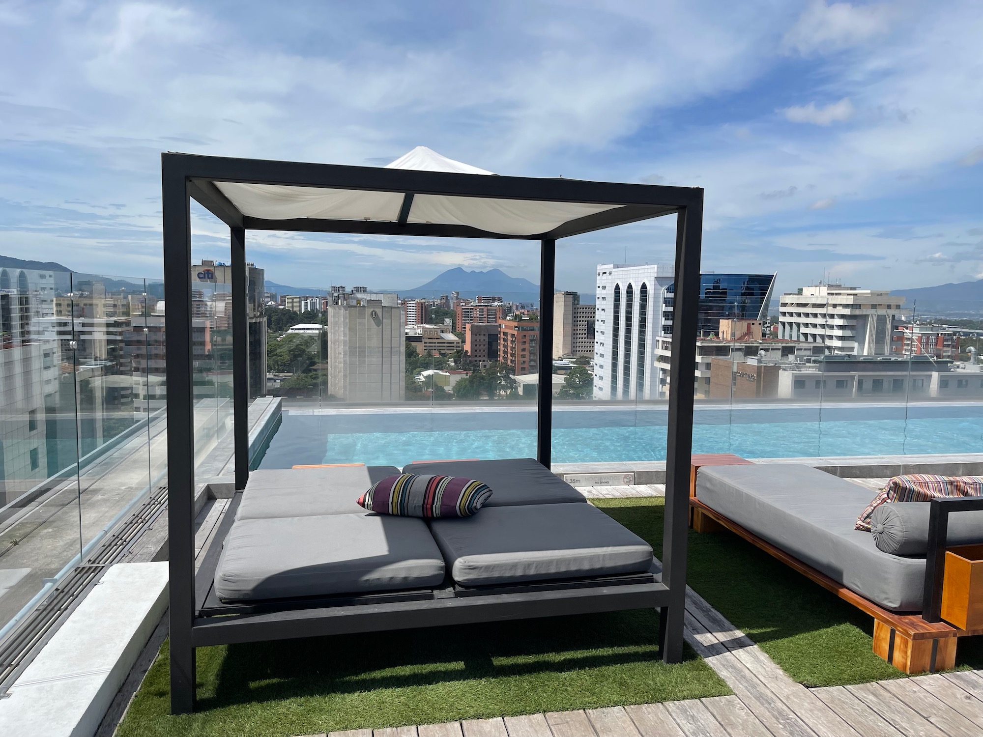 a patio with a pool and a bed