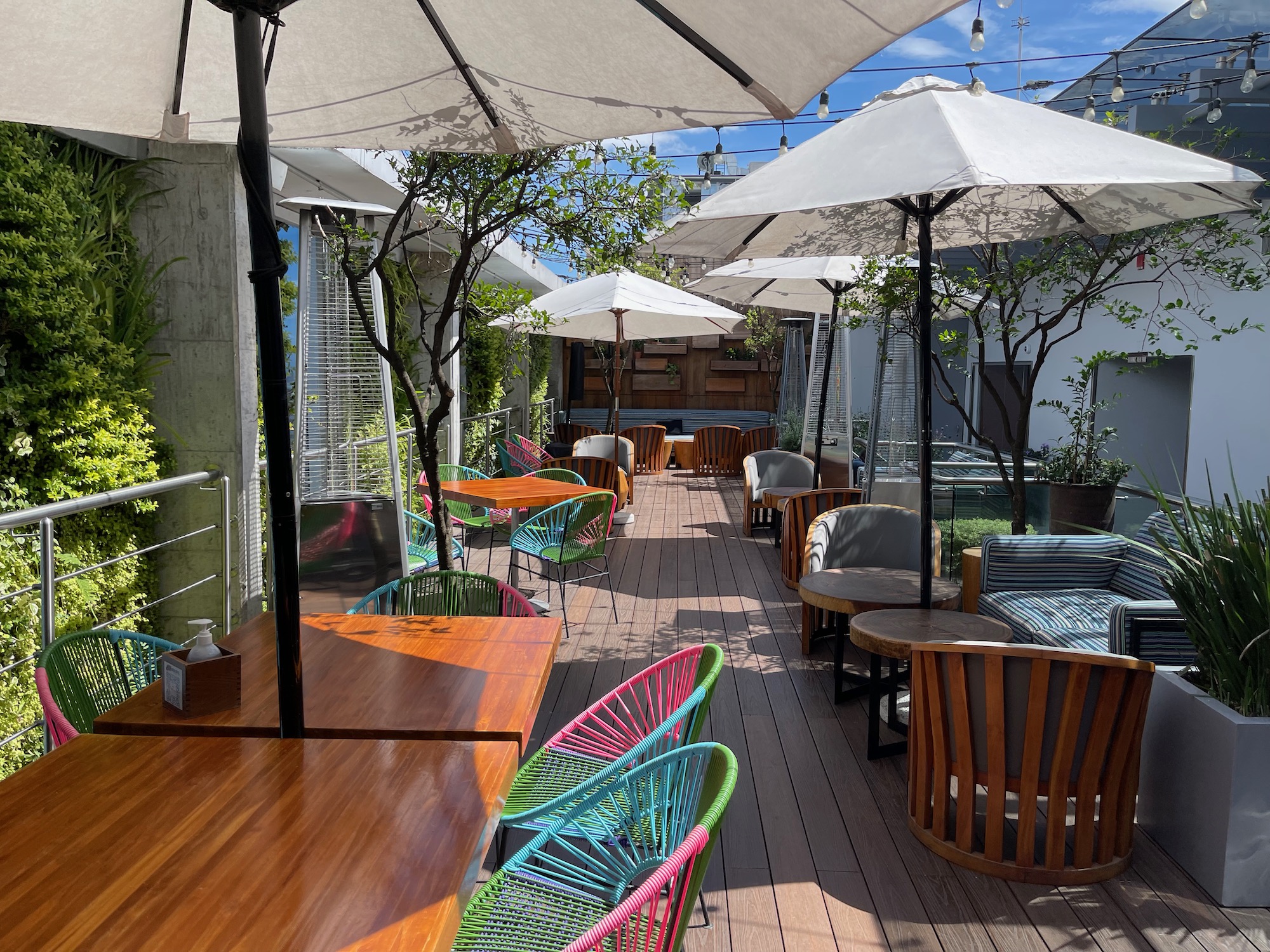 a patio with tables and chairs and umbrellas